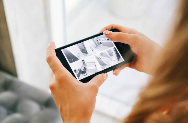 caucasian-woman-monitoring-security-cameras-on-smartphone-indoors-closeup-1-1.jpg