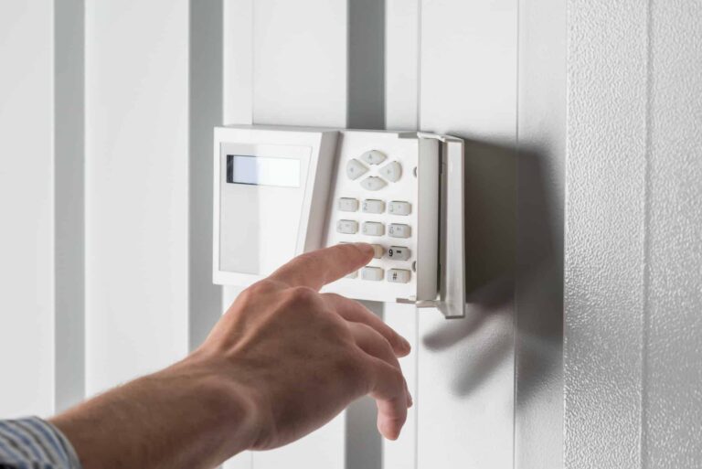 person-typing-on-keypad-of-home-security-alarm-security-system-concept.jpg
